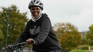 Cllr Naima Ali pictured on a bike for the first time.