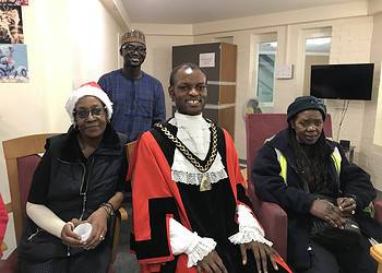 Left to right: Tenant Jenny Powell, Southwark Mayor Michael Situ and local resident Maggie Chibangu. Back: Manager Abdul Saluh