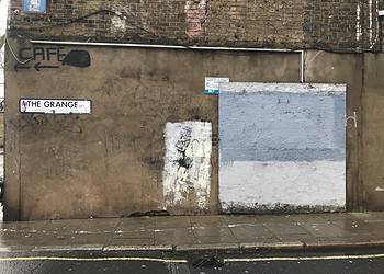 A board covers where the Banksy artwork used to be on The Grange