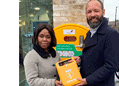 Cllr Evelyn Akoto (left) and Council Leader Kieron Williams (right) presenting one of the new defibrillators