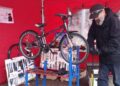A technician working on a bike at one of the markets previously held at The Blue